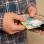 midsection-man-removing-paper-currencies-from-wallet_1048944-26720206