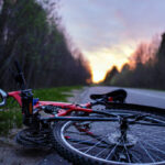 The bike lies on the roadway of the asphalt road in the lem